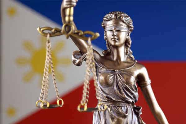 Legal statue in front of Philippine flag